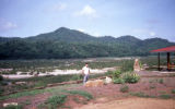 Tim standing on the shore of the Mekong Riverwhen it is dry