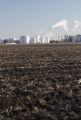 Ethanol plant at Lamberton, Minnesota with corn residue plowed under in field.