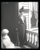 Mrs. Roberts on porch in front of Dr. Roberts's office laughing