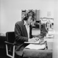 Student at KUMD with headphones and microphone