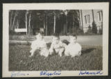 Chester Adgate Congdon II sitting in between John and David Hartley on the lawn in front of the house of Cavour Hartley at 3800 East Superior Street