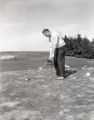 Action shot of UMD 1963 golfer getting ready to put