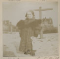 Judith Hartley standing in the snow holding a doll