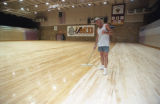 A person polishing the floor of the Romano Gymnasium on the UMD campus