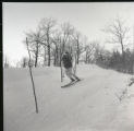 Action shot of UMD 1965 downhill skier on the slopes