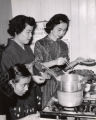 Three Japanese-American women prepare dinner