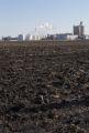 Ethanol plant at Lamberton, Minnesota with corn residue plowed under in field.