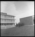 Two people walking outside a building on upper UMD campus