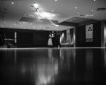 Three people standing in a ballroom at UMD