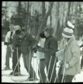 Action shot of UMD 1976 downhill skiers lined up at the top of the slope