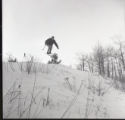 Action shot of UMD 1965 skier doing a jump