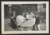 Carrie Eliza Hartley sitting beside Clara, G.G.H., and John Congdon on a patio at Congdon Castle