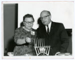 Mrs. Anna Chargo and Louis Perlman light the menorah at a senior citizen event at the St. Paul Jewish Community Center