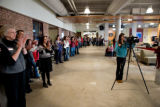 Crowd gathered against a back wall at the opening ceremony of Kirby Student Center
