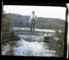 John Nordquist standing on planks above the Burntside Lake outlet, St. Louis County
