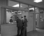 Three people in military uniforms standing at the Kirby Student Center information desk