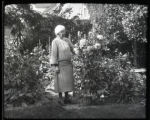 Mrs. Crosby in her garden with Dahlias