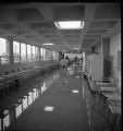 A person walking down a hallway with water on the floor in the Science Building at UMD