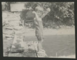 Child standing on the edge of a dock in Cass Lake