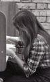 Student reading in library cubicle