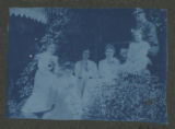 Members of the Hartley family sitting on the steps to a cabin at Cass Lake