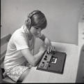 Student listening to cassette tape in library