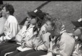 UMD 1989 women's softball team sitting on bench during a game