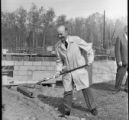 A person shoveling at the groundbreaking ceremony of the WDSE-TV station building on the UMD campus