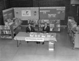 Educational Research and Development staff sitting at an informational booth