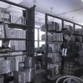 Students among bookshelves in the Curriculum Library