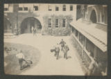Several groups of people walking through the courtyard of the Hill School