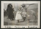 Carrie Eliza Hartley walking down a sidewalk with Caroline and Clara Congdon