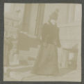 Carrie Eliza Hartley standing outside the Hartley house at 1305 East Superior Street