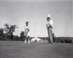 Action shot of UMD 1961 golfer putting ball during free golf