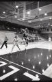 Action shot of UMD 1991 women's basketball player jumping to catch ball during a game