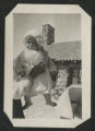Chester Adgate Congdon II as a baby being held up by an unidentified adult in front of a Congdon Castle