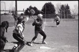 Action shot of UMD 1988 women's softball player getting ready to hit ball