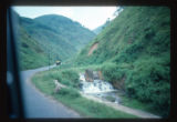 Stone Forest to Kunming by bus. Road through steep walled valley