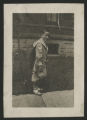 Child standing near a sidewalk by the Hartley house at 1305 East Superior Street