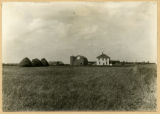 Farmhouse and barn without tree of any kind