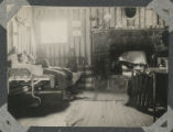 Group of three people sitting around a fireplace in a cabin at Tettegouche State Park