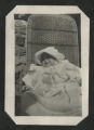 Chester Adgate Congdon II as a baby sitting in a wicker chair outside of Congdon Castle
