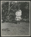 Child standing in the yard outside of the Hartley house at 1305 East Superior Street