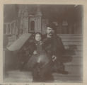 Judith Hartley sitting in someone's lap on the steps of the Hartley house at 1305 East Superior Street
