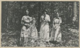 Members of the Hartley family standing in the woods near the maple sugar camp in Trout Lake