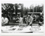 Picnic food and visitors outside of Dining Hall during 75th Anniversary Celebration