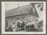 Members of the Hartley family in front of a chapel at Cass Lake