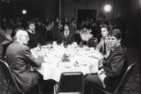 Table of guests at dinner during Jeno's Holiday Classic men's hockey tournament