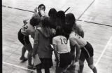 UMD 1977 women's volleyball team huddled during game