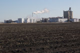 Ethanol plant at Lamberton, Minnesota with corn residue plowed under in field.
